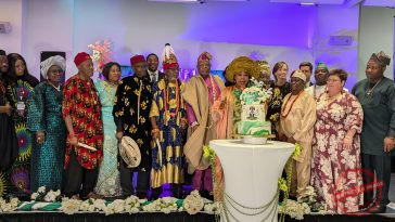 Evangelist Alao with elders of the Nigerian community cutting the anniversary caje